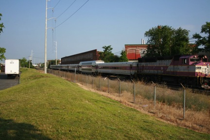 FIGURE 10. Commuter Rail Line behind Mystic Mall: Site of Furture Chelsea Commuter Rail Station
Figure 10 shows an MBTA commuter train, a fence between the MBTA and shopping center property, and a semi-trailer resting in the shopping center loading dock area.
