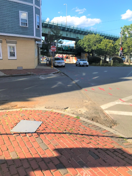 Scarified pavement without marked crosswalk where Chestnut Street meets Everett Avenue.