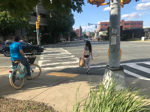 Figure 12
A bicyclist and pedestrian begin to cross the intersection after sharing sidewalk space while waiting for the pedestrian signal. 