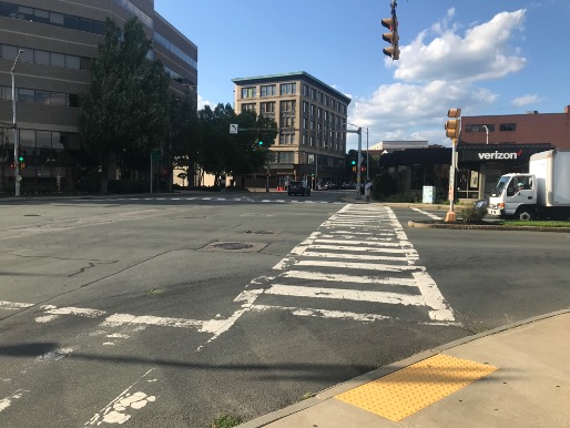 Figure 9
Apex curb ramp on the southwest corner of the intersection directing pedestrians into the middle of traffic instead of along the path of either crosswalk. 