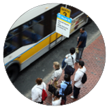 A photo of passengers waiting to board an MBTA bus.